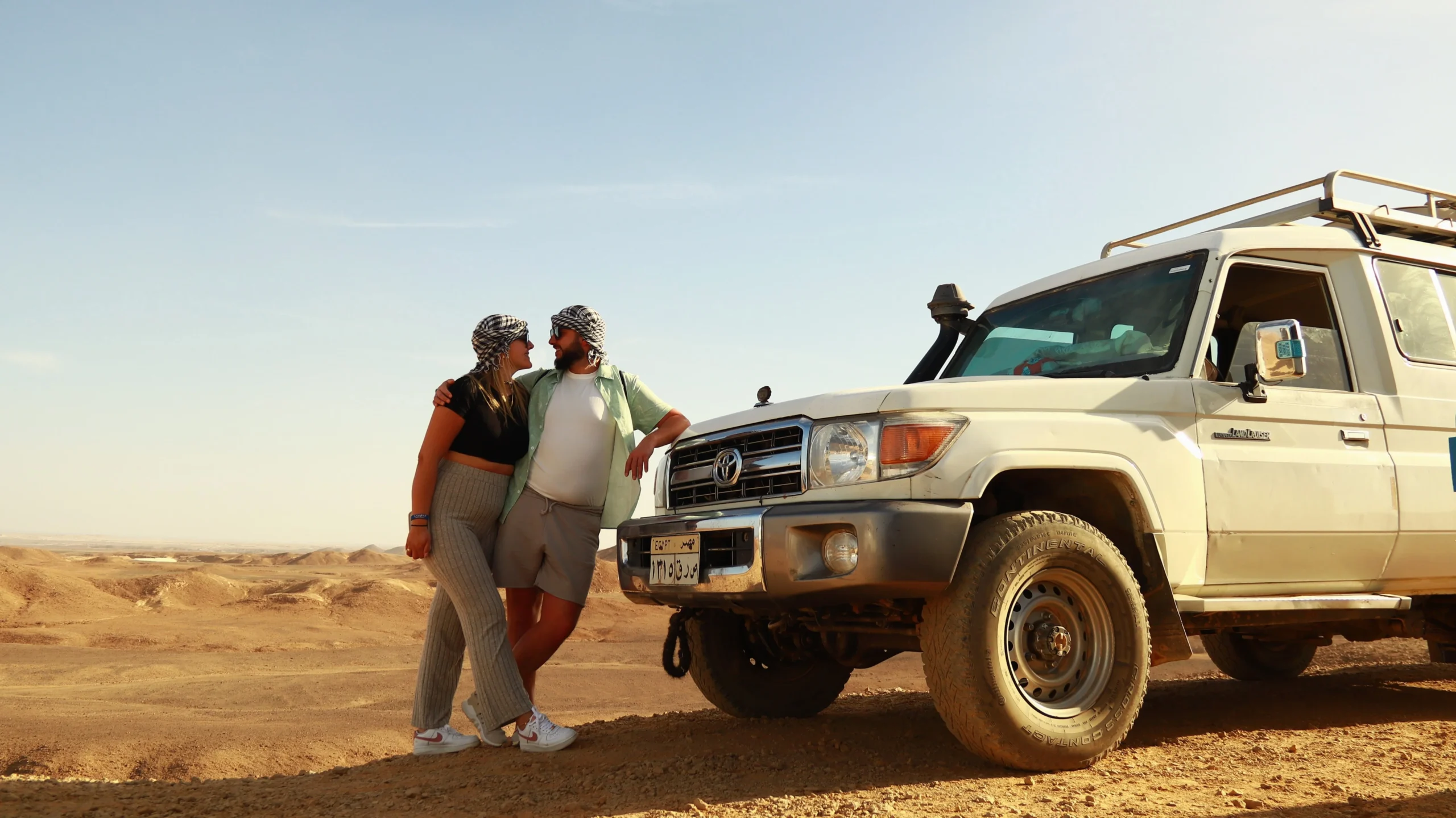 super safari tour a couple pausing briefly at a panoramic mountain view.wepb