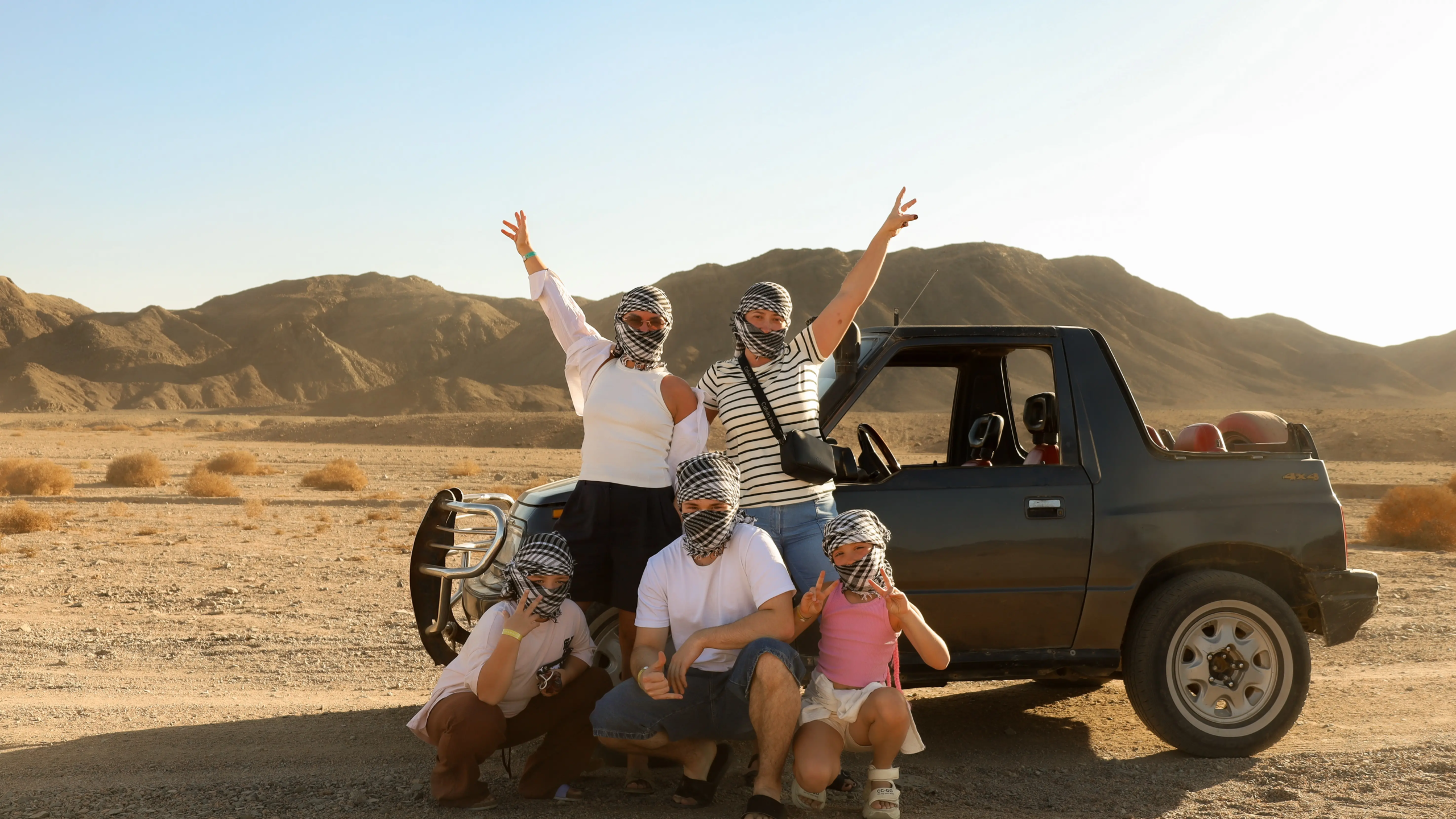 star gazing marsa alam safari tour a family posing next suzuki 4x4
