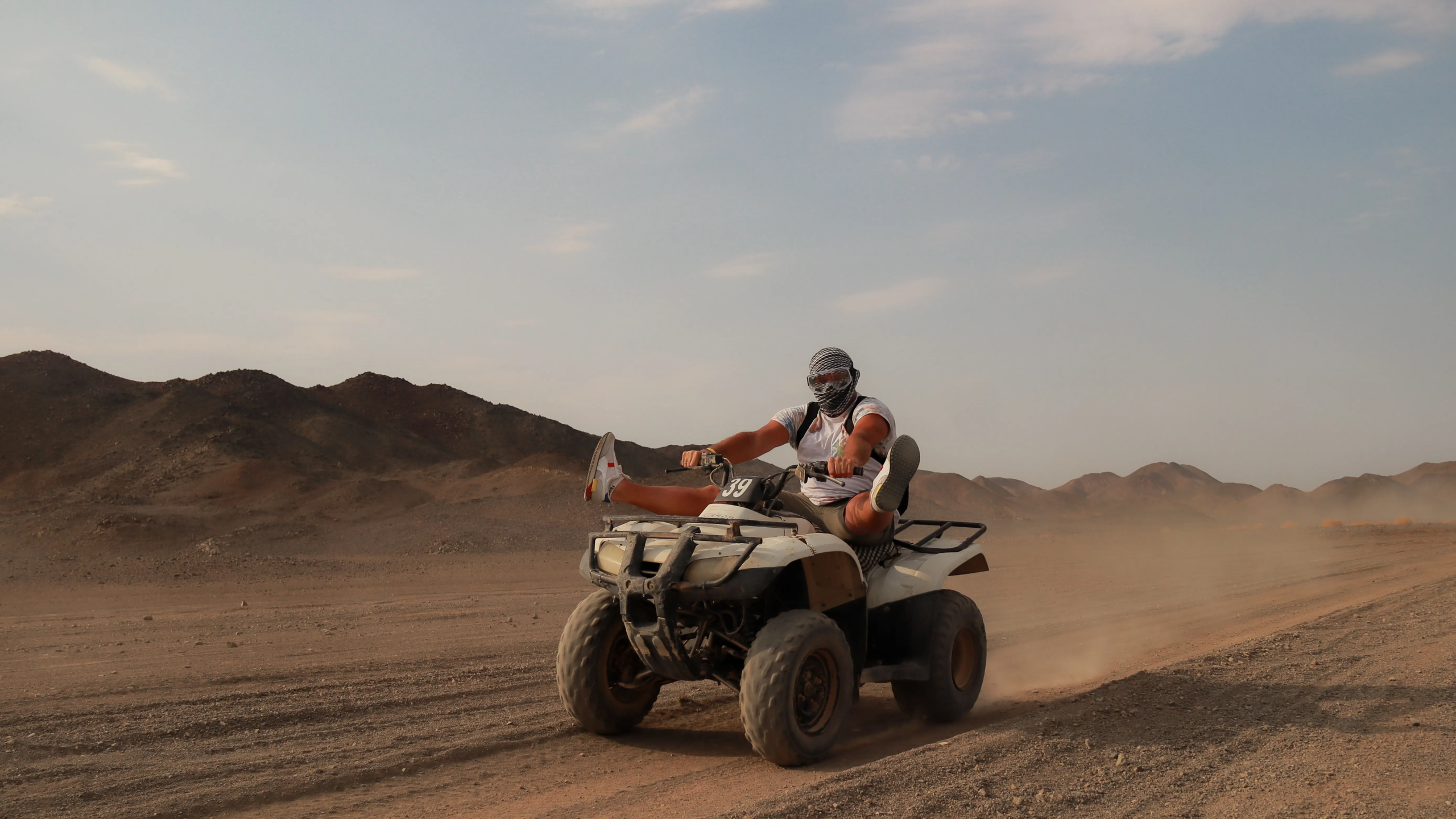 tourist driving fast the quad in the red sea desert with red sea tours locatedl in marsa alam desert photo by falcon photography .webp